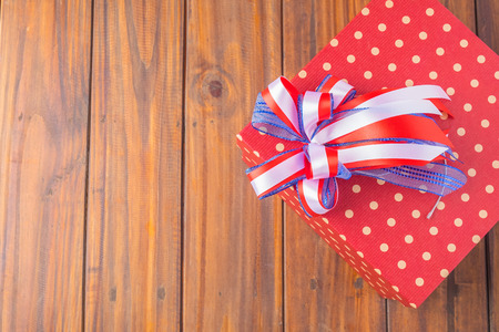 gift box on wooden background .vintage tone Retro filter effect,soft focus,low light.space for text.selective focusの写真素材