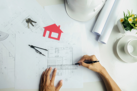 Hands of Engineer working on blueprint,Construction concept. Engineering tools.Vintage tone retro filter effect,soft focus(selective focus)の写真素材
