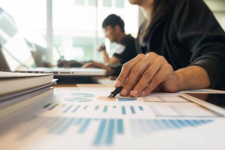 Business concept. Business people discussing the charts and graphs showing the results of their successful teamwork.

の写真素材