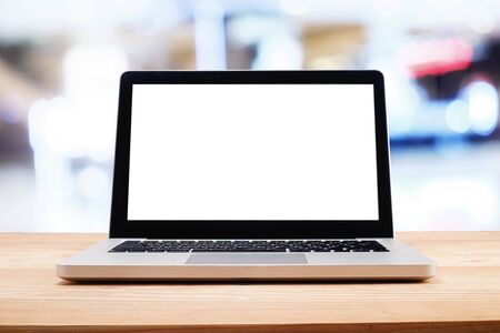 Computer with white screen on table with blur background. Technology concept.の写真素材