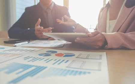 Business concept. Business people discussing the charts and graphs showing the results of their...