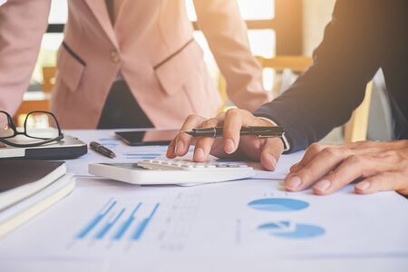 Business concept. Business people discussing the charts and graphs showing the results of their successful teamwork. Selective focus.の写真素材