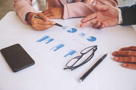 Business concept. Business people discussing the charts and graphs showing the results of their successful teamwork.Accountingの写真素材