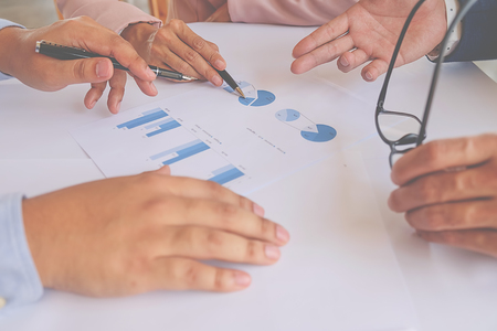 Business concept. Business people discussing the charts and graphs showing the results of their successful teamwork.の写真素材