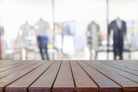 Empty wooden table space platform and blurred shopping mall or shopping center background for product display montage.の写真素材