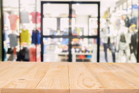 Empty wooden table space platform and blurred shopping mall or shopping center background for product display montage.の写真素材