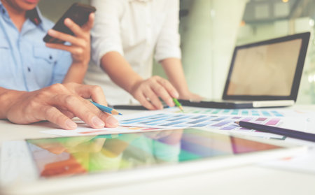 Graphic design and color swatches and pens on a desk. Architectural drawing with work tools and...