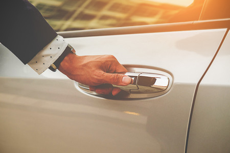 Cropped image of businessman opening door on his carの写真素材