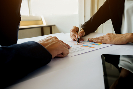 Business concept. Business people discussing the charts and graphs showing the results of their successful teamwork. Selective focus.の写真素材