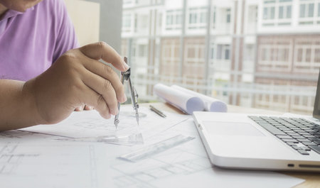 Hands of Engineer working on blueprint,Construction concept. Engineering tools.Vintage tone retro...