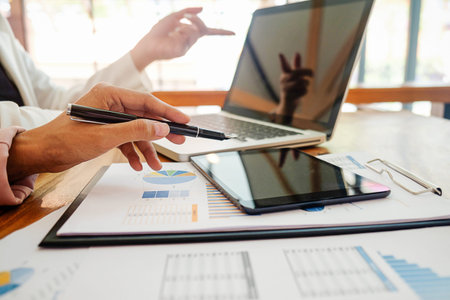 Business concept. Business people discussing the charts and graphs showing the results of their...