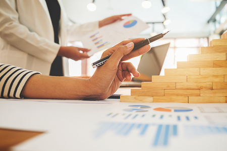 Business concept. Business people discussing the charts and graphs showing the results of their successful teamwork.の写真素材