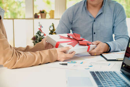 Group of young business people are sitting in Santa hats in last working day. young creative people are celebrating holiday in modern office. Merry Christmas and Happy New Year 2018の写真素材