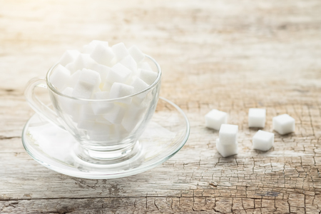sugar in cup on wood table.Vintage tone retro filter effect,soft focus(selective focus)の写真素材