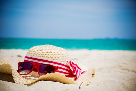 Summer vacation concept with accessories on sandy beachの写真素材