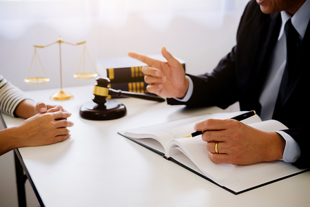 Judge gavel with Justice lawyers having team meeting at law firm in background. Concepts of law.の写真素材