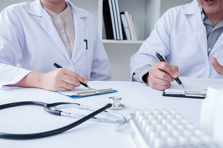 Doctor discussing something, just hands at the table.の写真素材