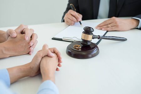 Judge gavel with Justice lawyers deciding, consultation on marriage divorce between married couple and signing divorce documents on table. Concepts of Law and Legal sevices.の写真素材