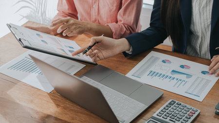 Business concept. Business people discussing the charts and graphs showing the results of their...