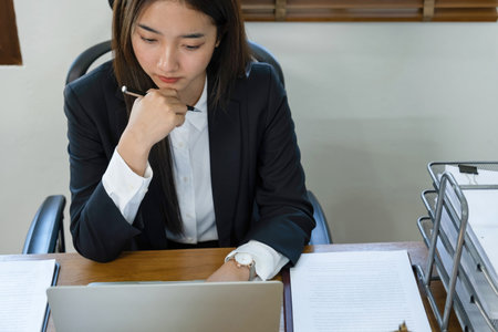 Young Asian businesswoman working with laptop computer in office. Business concept.