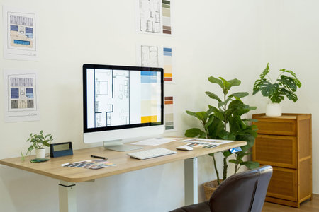 Interior of modern office with computer, tablet and other items.