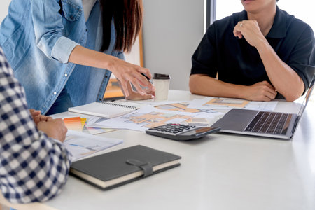 Business people discussing the charts and graphs showing the results of their successful teamworkの写真素材