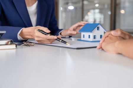 Real estate agent or real estate agent giving keys to customer after signing contract.の写真素材