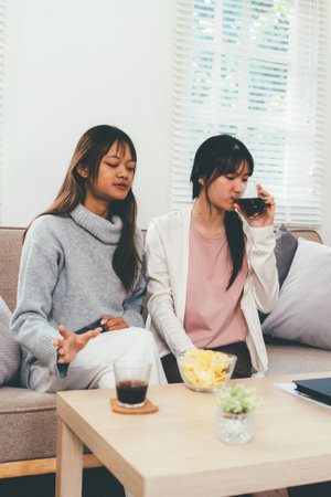 Female higher education student using laptop in home, Online learning.の写真素材