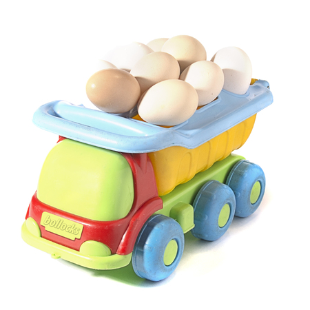 chicken eggs on toy car on white background with blank card. Abstract retro concept.の写真素材