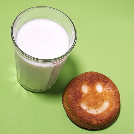 a glass of milk with a donutの写真素材