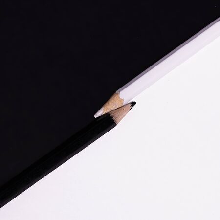 pencils on white and black background conceptual approachの写真素材