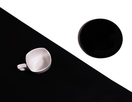 cups and saucers on white and black backgroundの写真素材