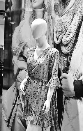 Full-size women's-children's mannequin, dressed in beautiful clothes in the shop windowの写真素材