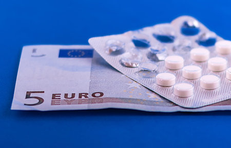 money for which to buy medical ampoules and a syringe isolated on a yellow background for the treatment of the heartの写真素材