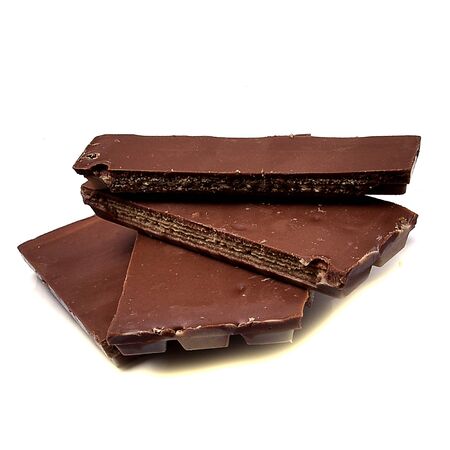 Pieces of delicious chocolate on a white background, intended for consumptionの写真素材