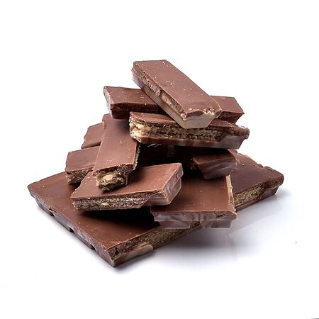 Pieces of delicious chocolate on a white background, intended for consumptionの写真素材