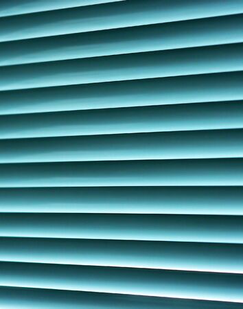 Sun-protection jalousie of blue color in a bright sunny dayの写真素材