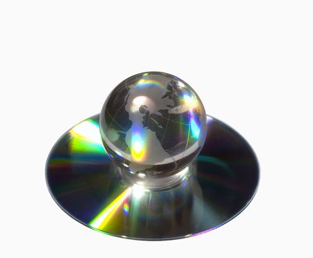 Glass globe of the World on a compact disk isolated on the whiteの写真素材