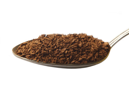 Spoon with coffee, close-up, isolated on whiteの写真素材