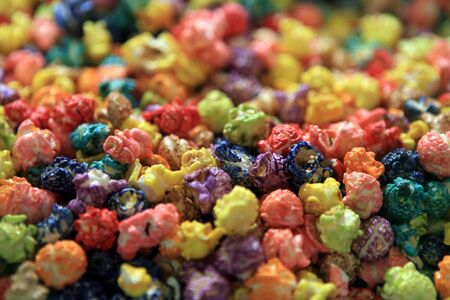 Grains of popcorn painted in different colorsの写真素材