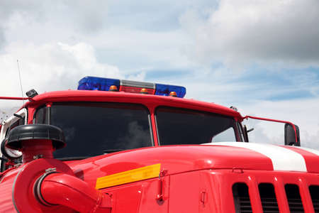 Closeup of fire truck top lights against blue sky background. の写真素材