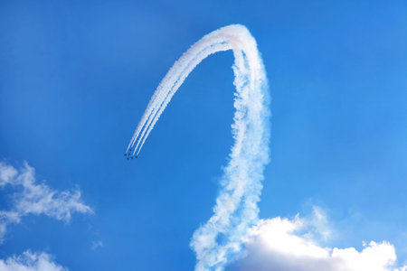 Six air show fighter planes in the sky making a figure 