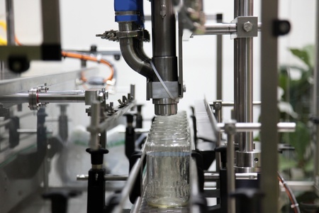 the automatic transfer line of packing of liquids in glass jarsの写真素材