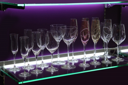 Wine Glasses on the Shelf with Violet Illuminationの写真素材