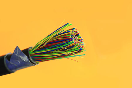 Telephone or telecommunication cable isolated on yellowの写真素材