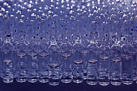 Ampoules with medicine closeup on blue backgroundの写真素材