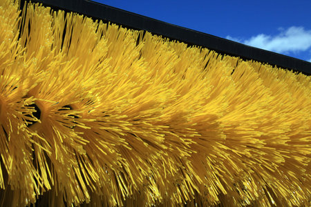 Brush street sweeper machine on blue sky backgroundの写真素材