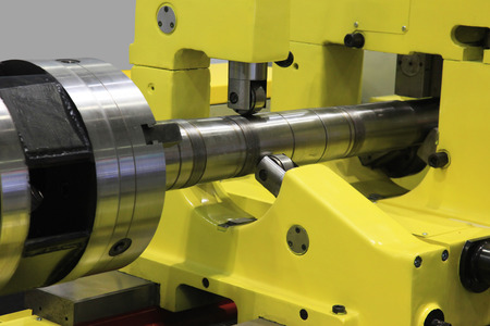 industrial metal work machining process of shaft by cutting tool on latheの写真素材