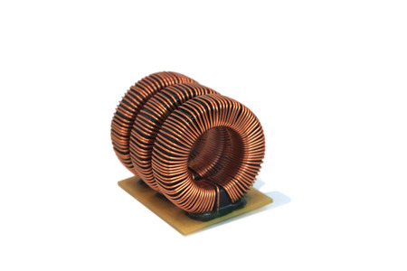 Three industrial toroidal choke coil isolated  on white backgroundの写真素材