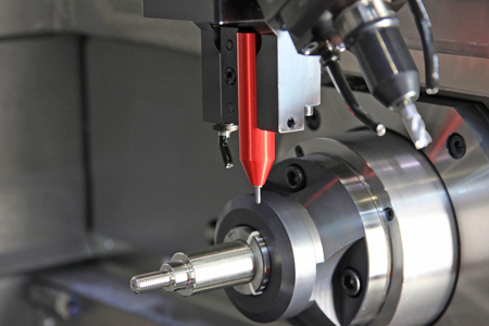Detail of the tip of a 3d laser scanner mechanical arm, with laser beam scanning a surface.の写真素材